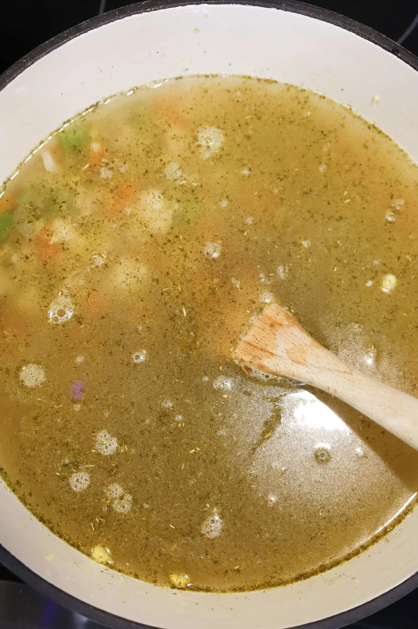 chicken broth and veggies in a pot