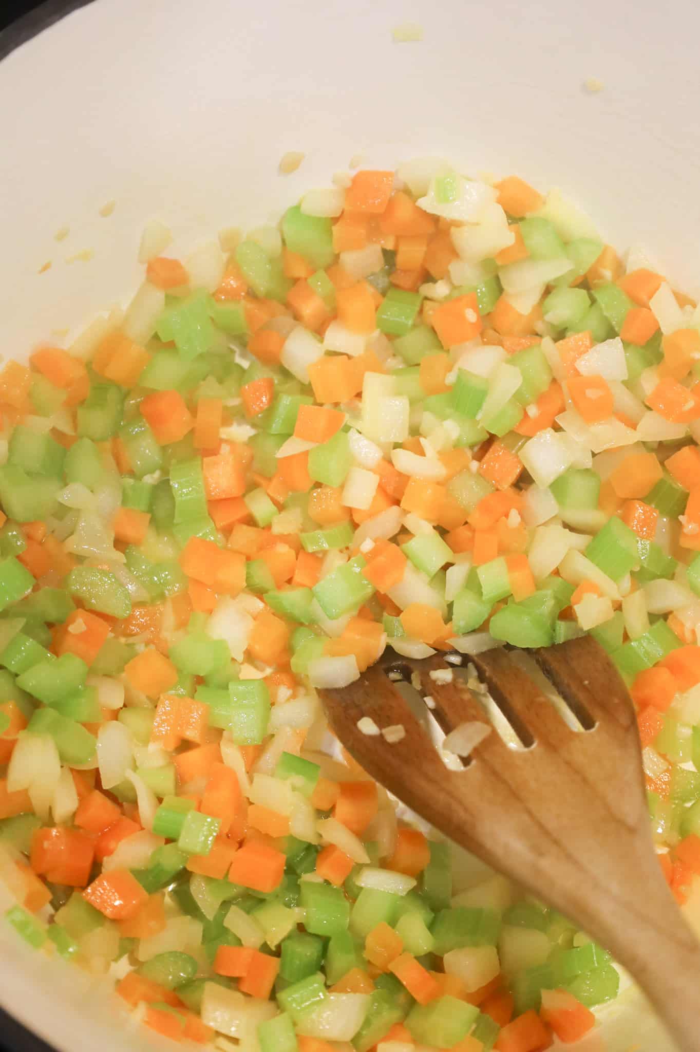 minced garlic and diced vegetables being stirred together