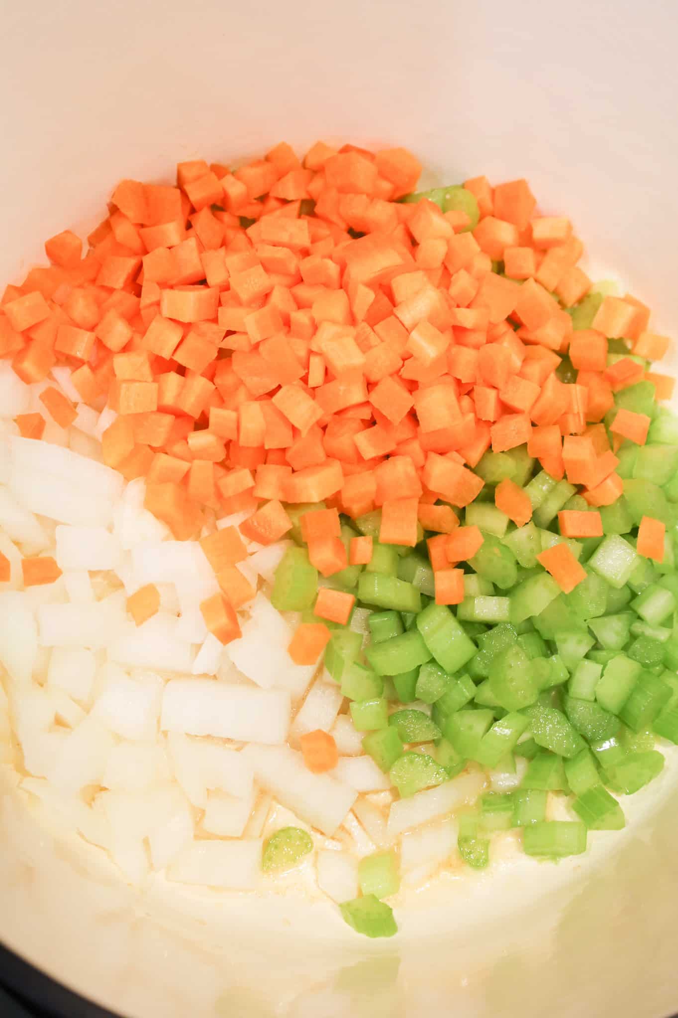 diced carrots, celery and onions in a pot