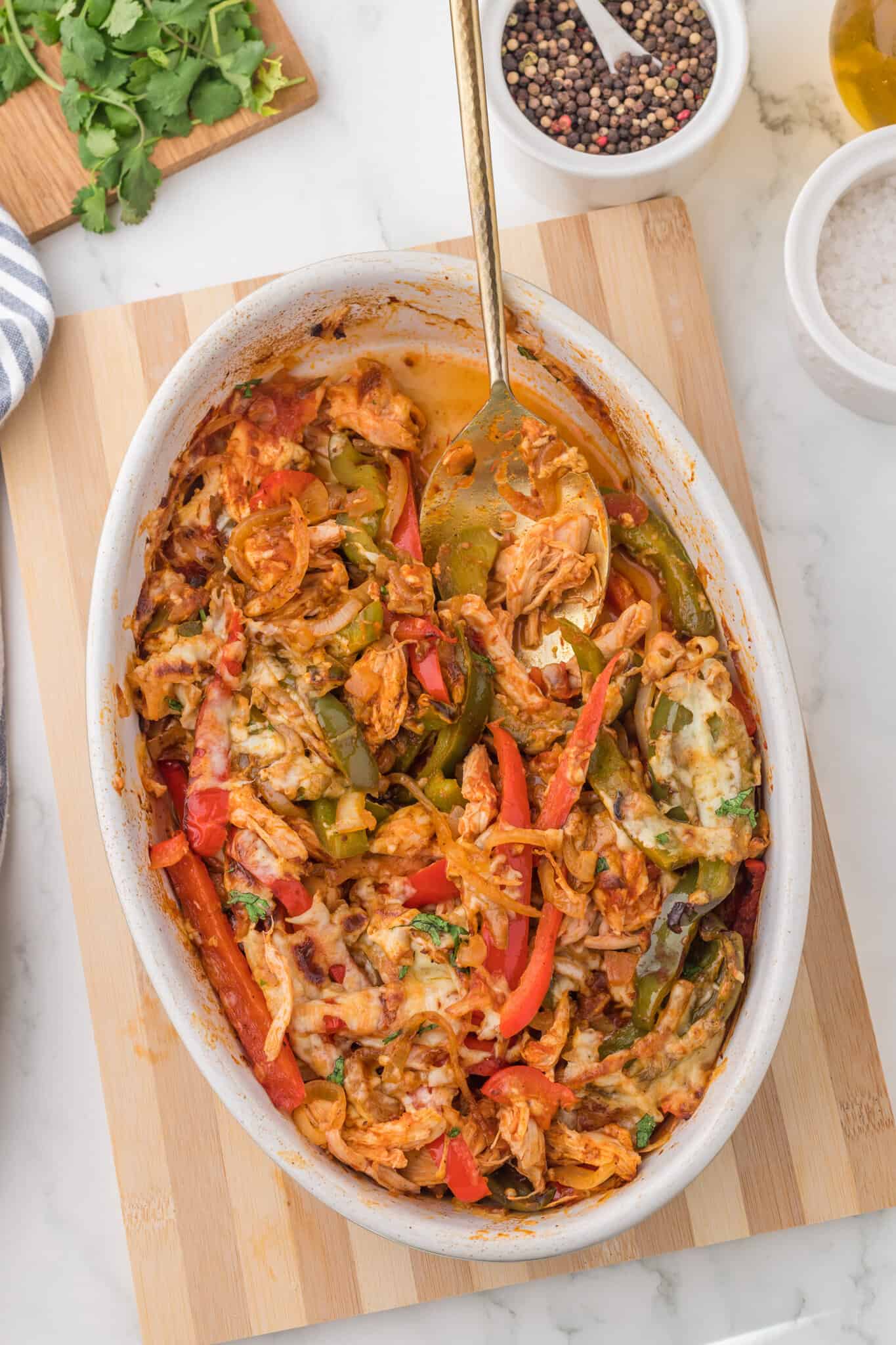 Chicken Fajita Casserole is a hearty casserole loaded with shredded chicken, bell peppers, onions, fajita seasoning, salsa and shredded cheddar cheese.