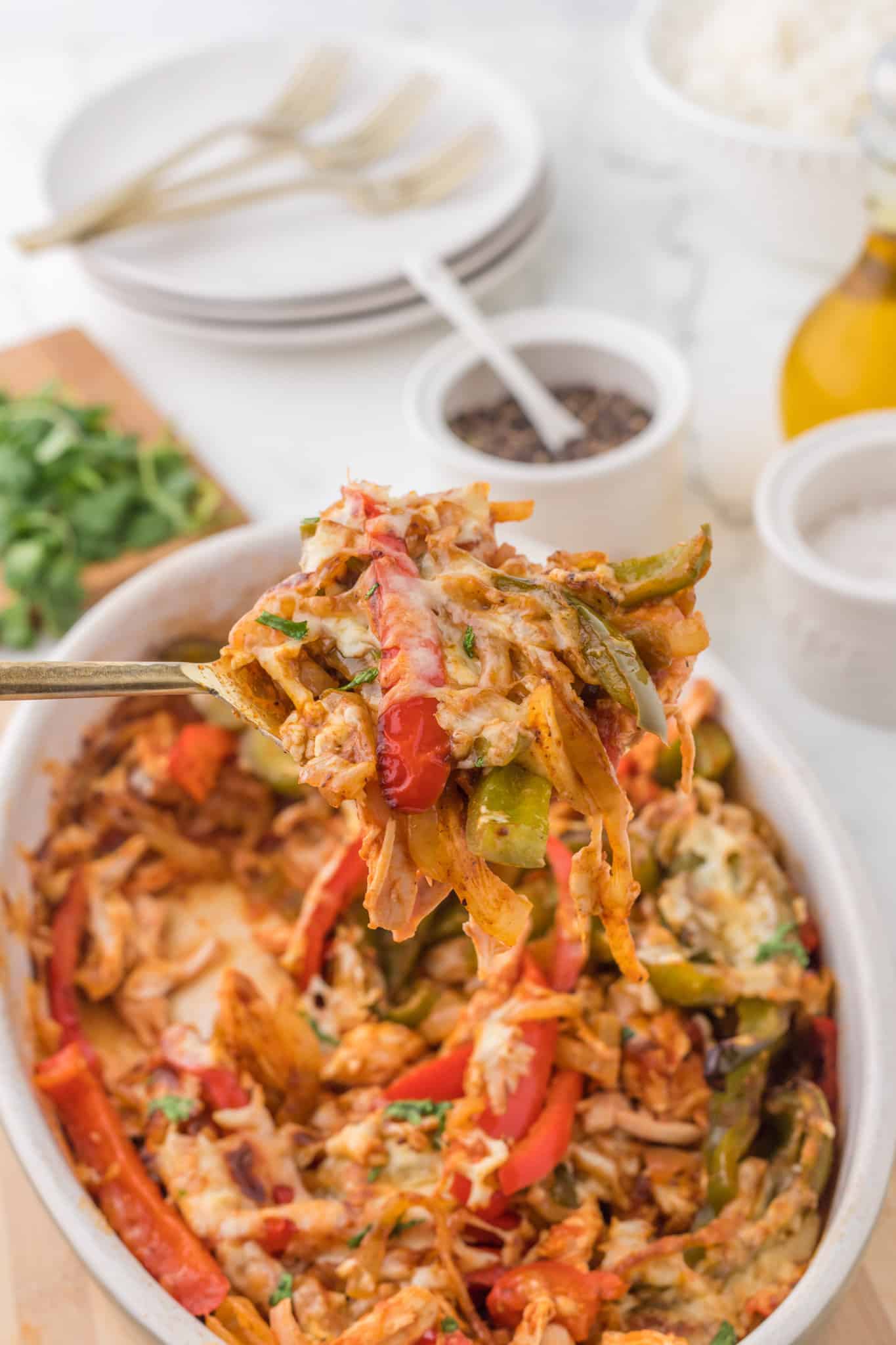 Chicken Fajita Casserole is a hearty casserole loaded with shredded chicken, bell peppers, onions, fajita seasoning, salsa and shredded cheddar cheese.