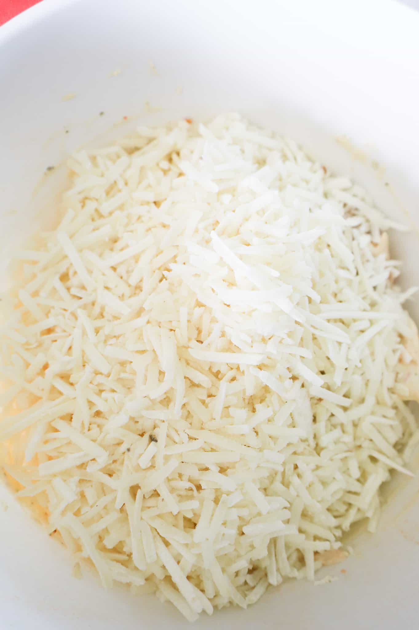 shredded hashbrown potatoes in a mixing bowl