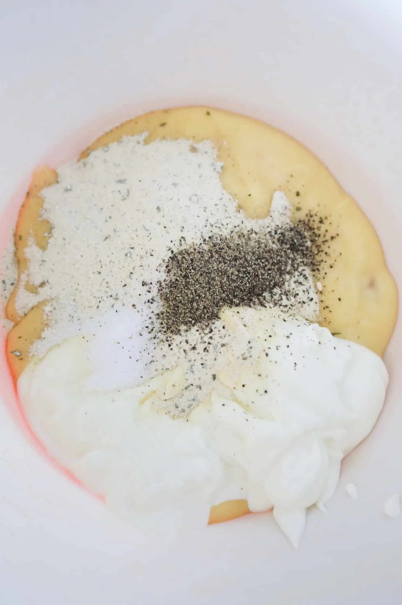 salt, pepper, ranch dressing mix, sour cream and cream of chicken soup in a mixing bowl