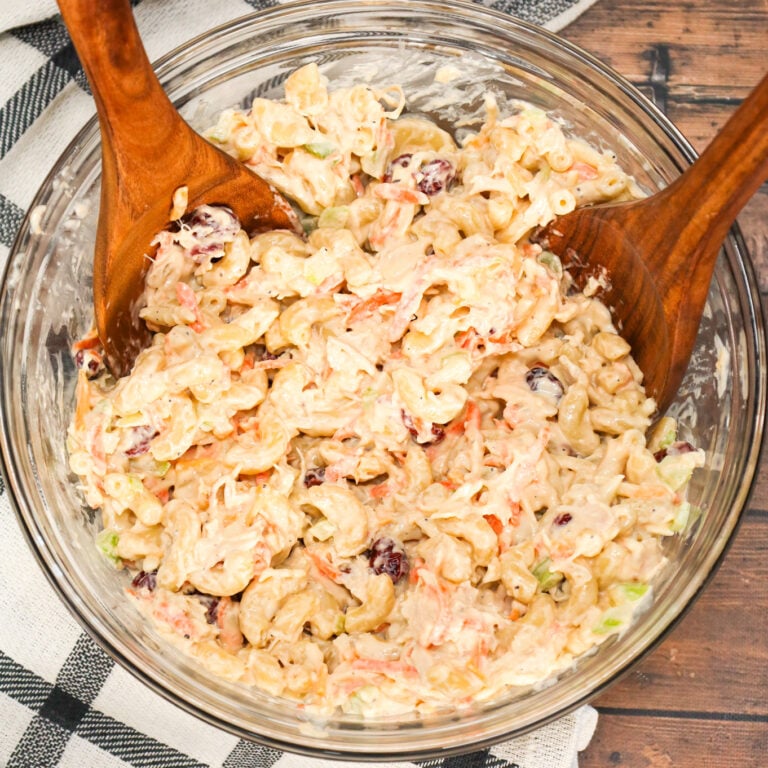 Chicken Macaroni Salad is a tasty pasta salad recipe loaded with carrots, onions, celery, mayo, chopped chicken, dried cranberries and shredded cheddar cheese.