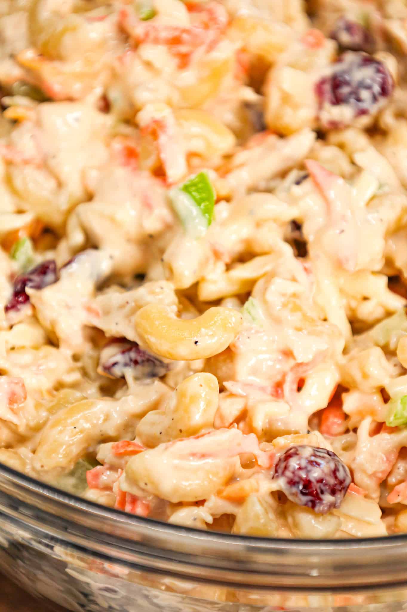 Chicken Macaroni Salad is a tasty pasta salad recipe loaded with carrots, onions, celery, mayo, chopped chicken, dried cranberries and shredded cheddar cheese.