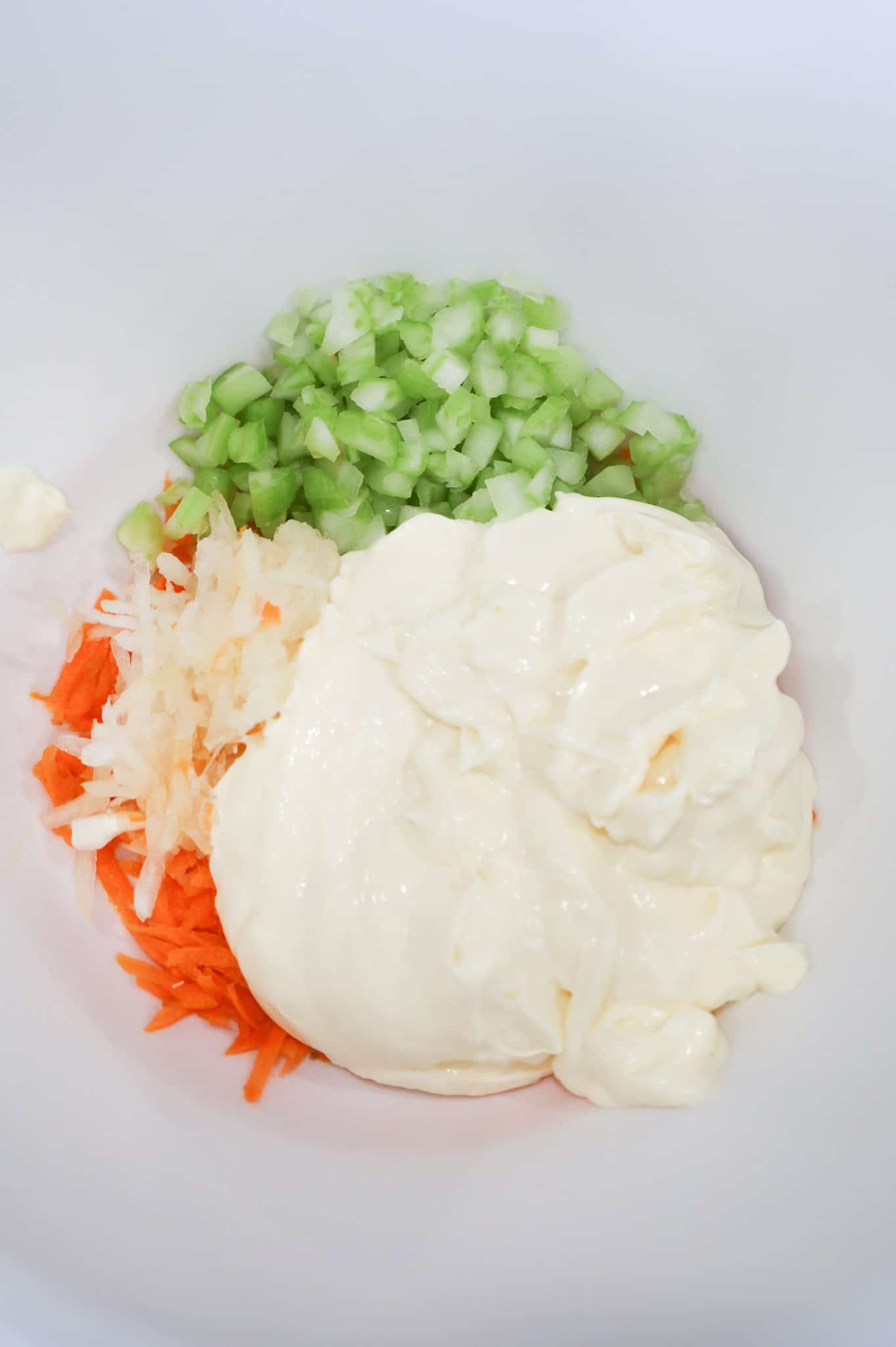 mayo, grated carrot, onion and celery in a mixing bowl