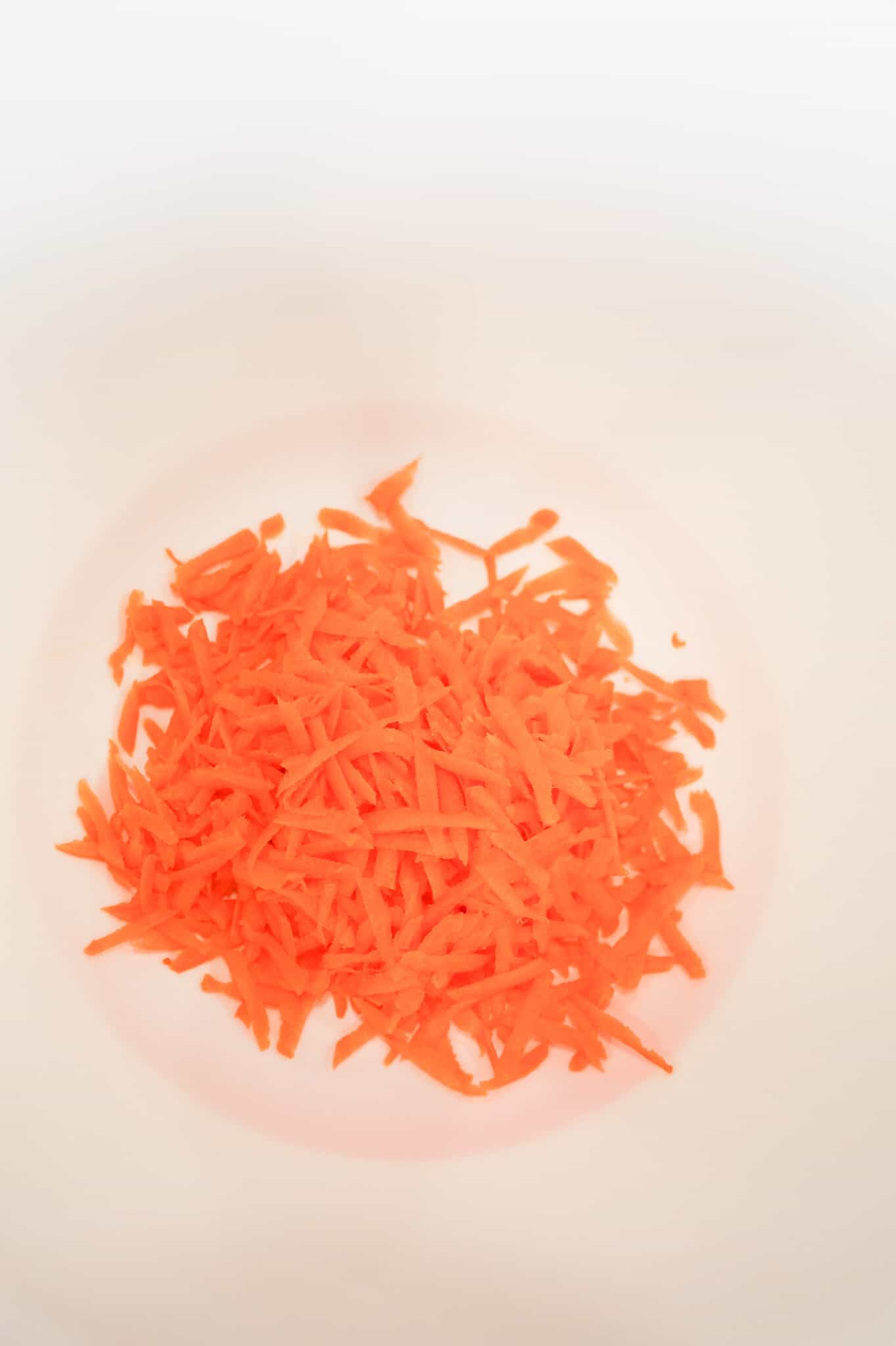 grated carrot in a mixing bowl