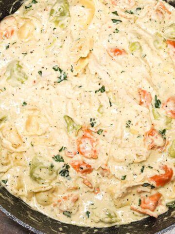 Chicken Tortellini Alfredo is an easy pasta recipe made with store bought cheese tortellini and shredded rotisserie chicken all tossed in a creamy garlic and parmesan sauce.