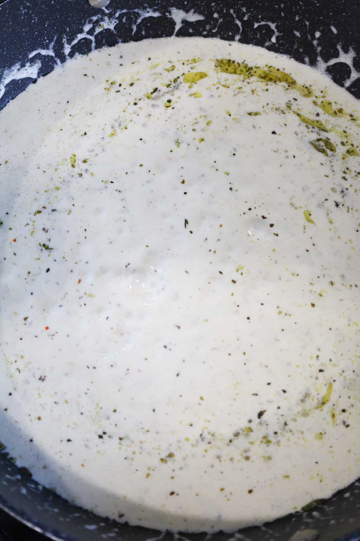 creamy garlic sauce simmering in a skillet