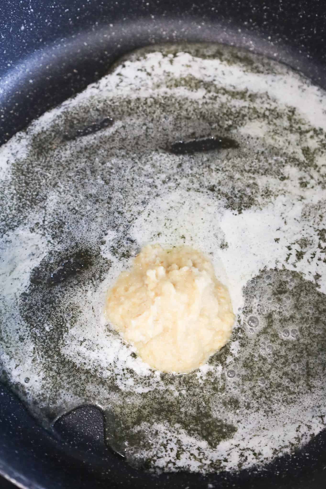 garlic puree added to skillet with melted butter