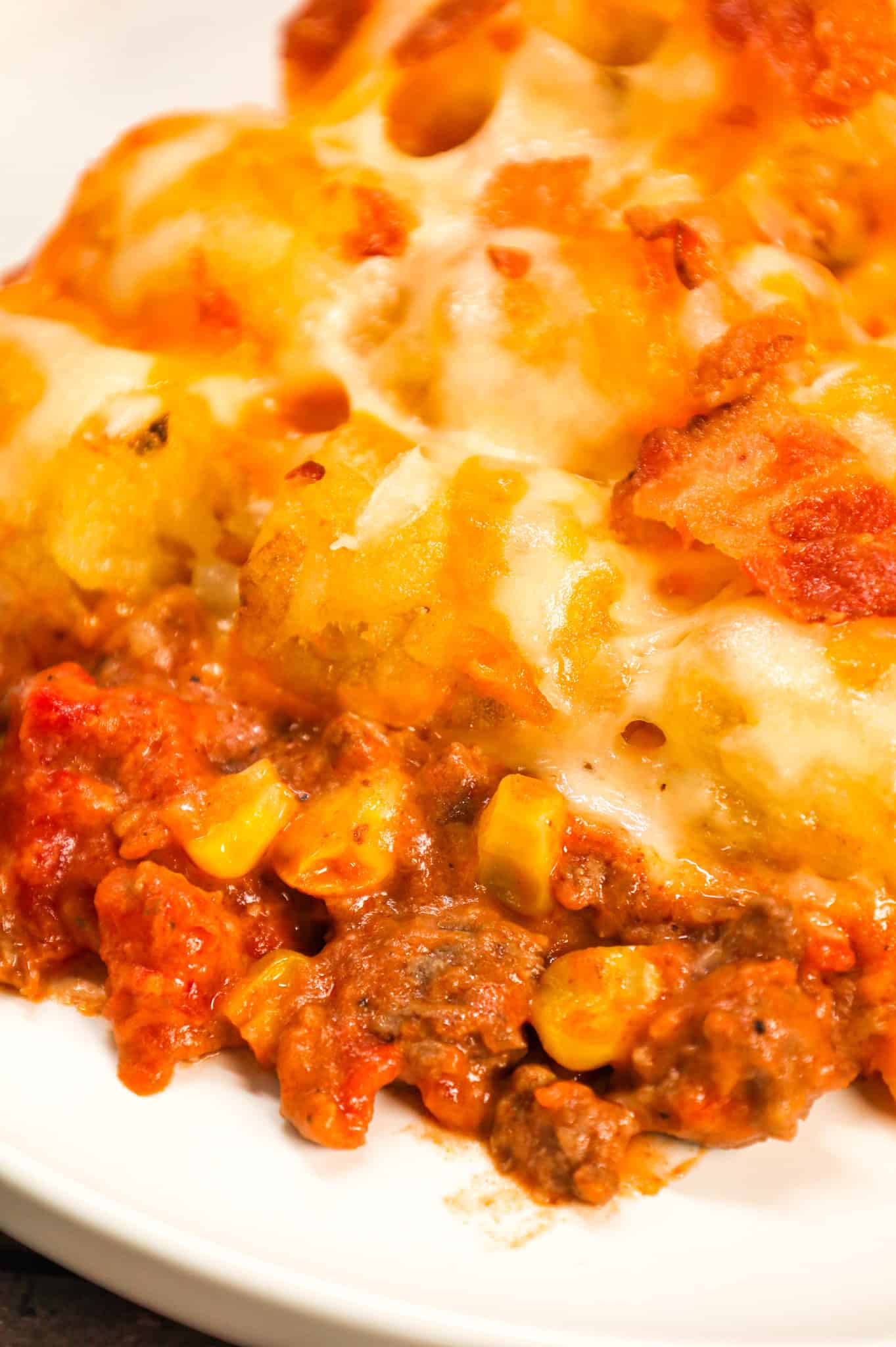 Cowboy Casserole is an easy ground beef casserole recipe loaded with diced tomatoes, corn, tater tots, shredded cheese and bacon.