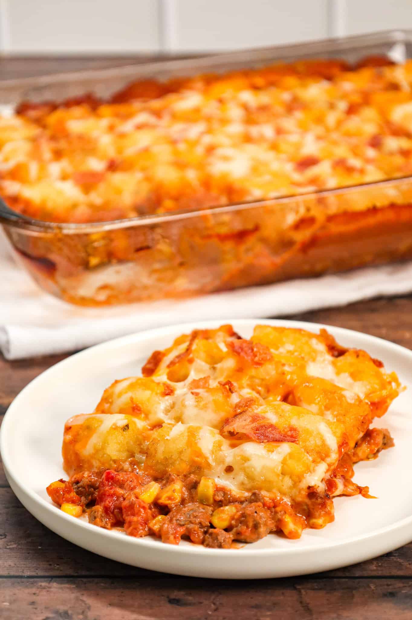 Cowboy Casserole is an easy ground beef casserole recipe loaded with diced tomatoes, corn, tater tots, shredded cheese and bacon.