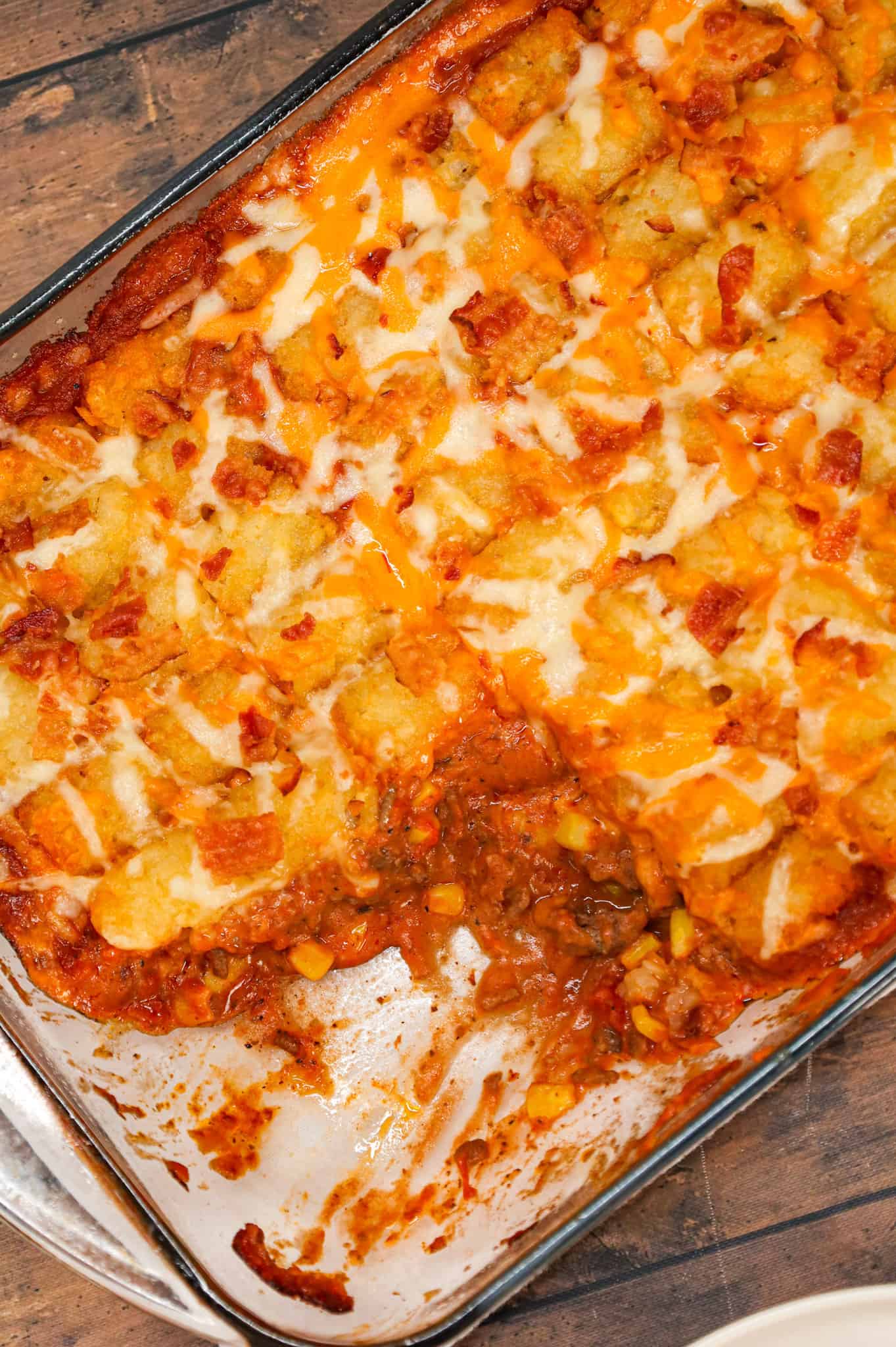 Cowboy Casserole is an easy ground beef casserole recipe loaded with diced tomatoes, corn, tater tots, shredded cheese and bacon.