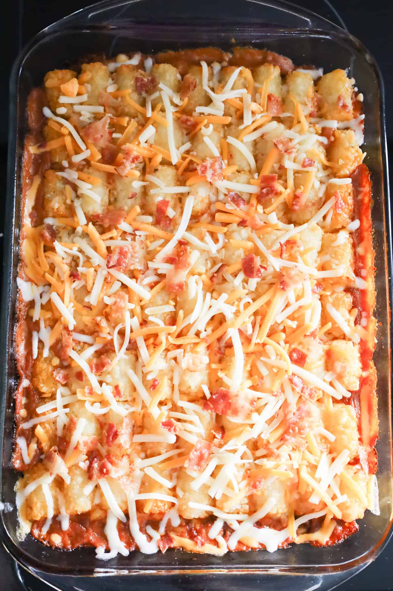 crumbled bacon and shredded cheese on top of tater tot casserole