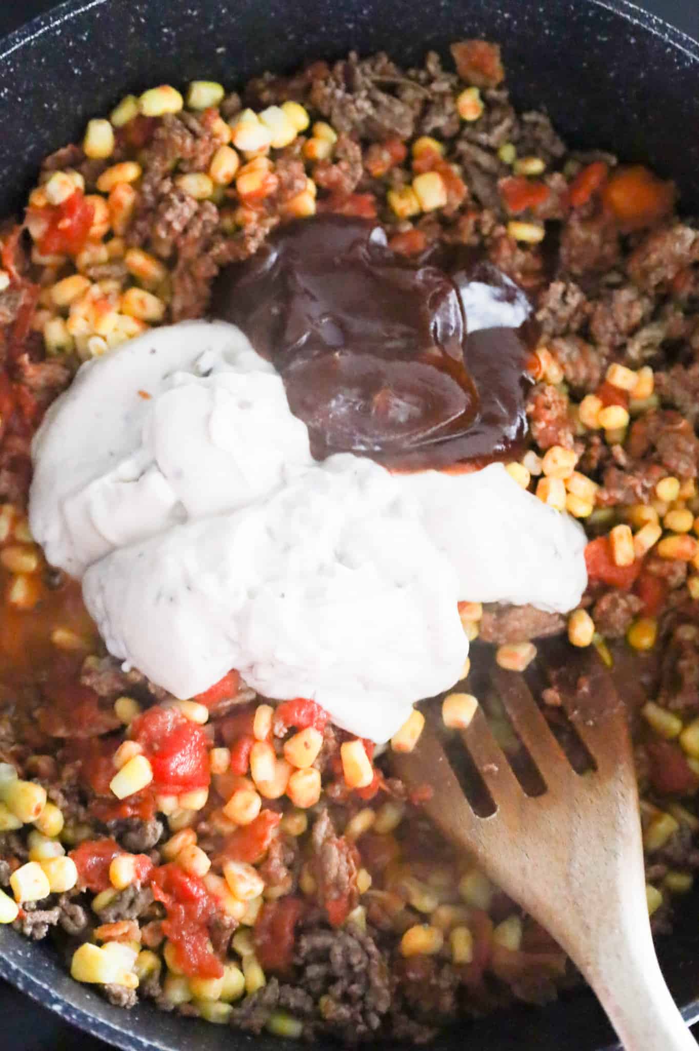 cream of mushroom soup and BBQ sauce on top of ground beef mixture in a skillet