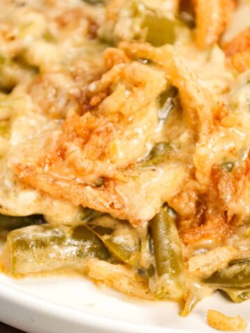 Crock Pot Green Bean Casserole is an easy slow cooker side dish recipe loaded with cut green beans, cream of mushroom soup, cheddar soup, cream cheese, provolone cheese and French's crispy fried onions.