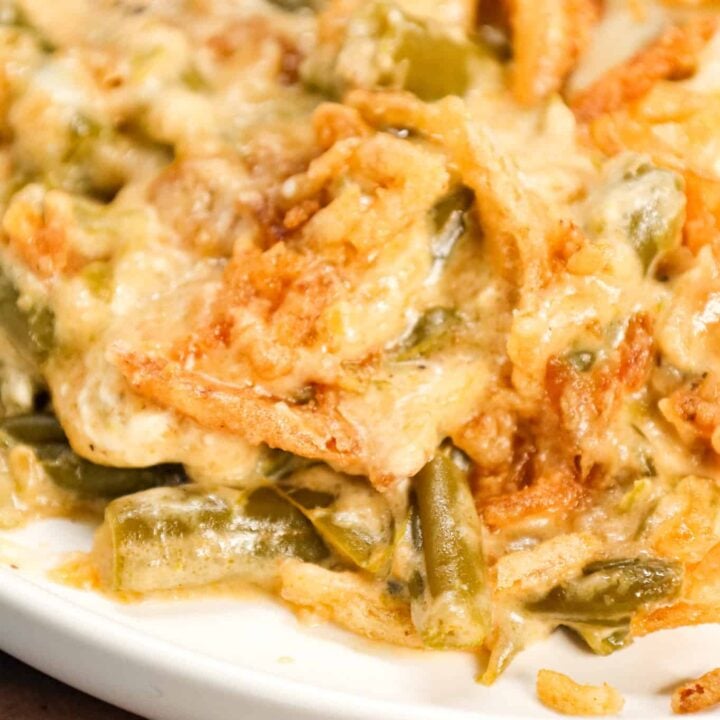 Crock Pot Green Bean Casserole is an easy slow cooker side dish recipe loaded with cut green beans, cream of mushroom soup, cheddar soup, cream cheese, provolone cheese and French's crispy fried onions.