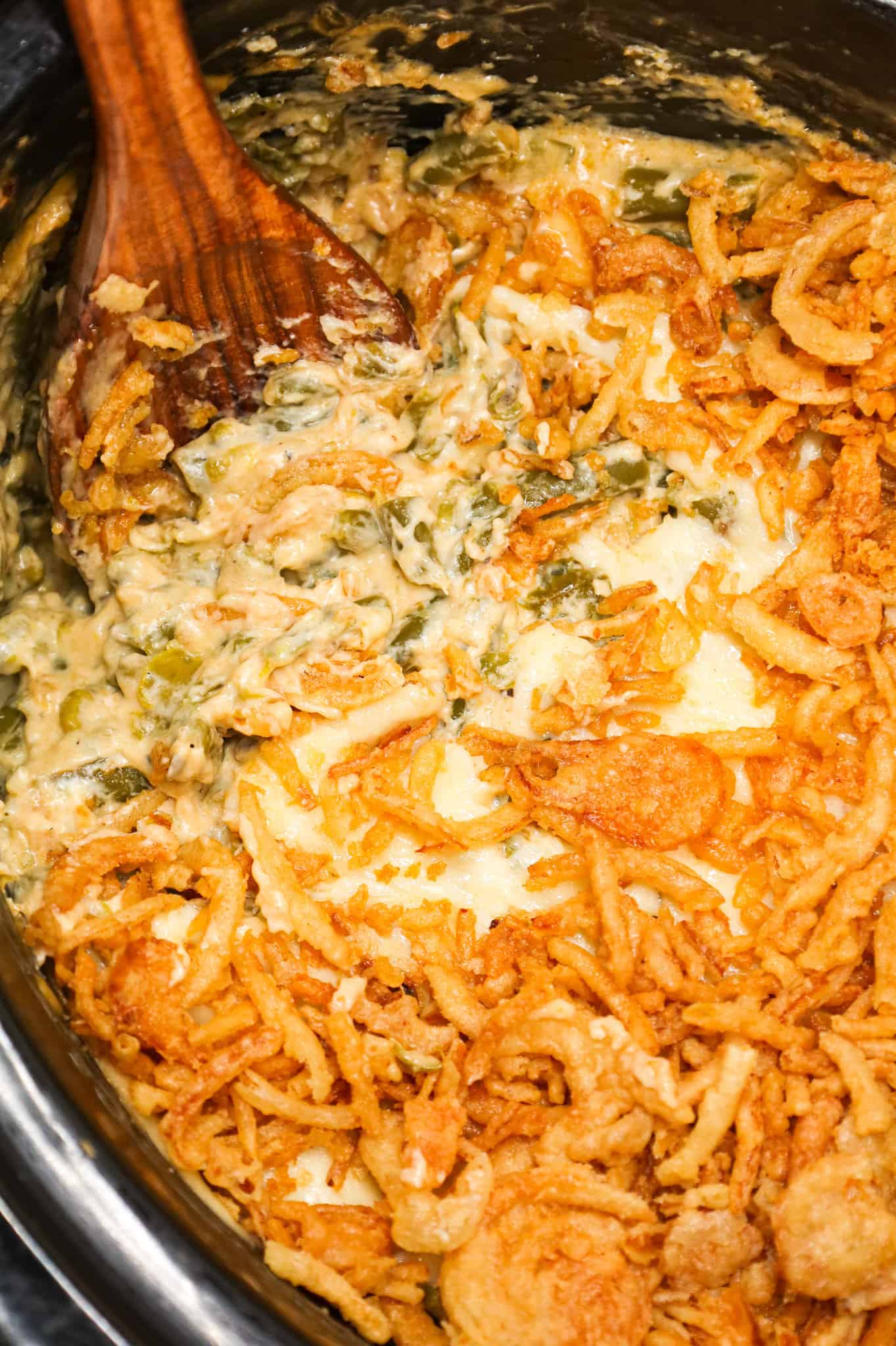 Crock Pot Green Bean Casserole is an easy slow cooker side dish recipe loaded with cut green beans, cream of mushroom soup, cheddar soup, cream cheese, provolone cheese and French's crispy fried onions.