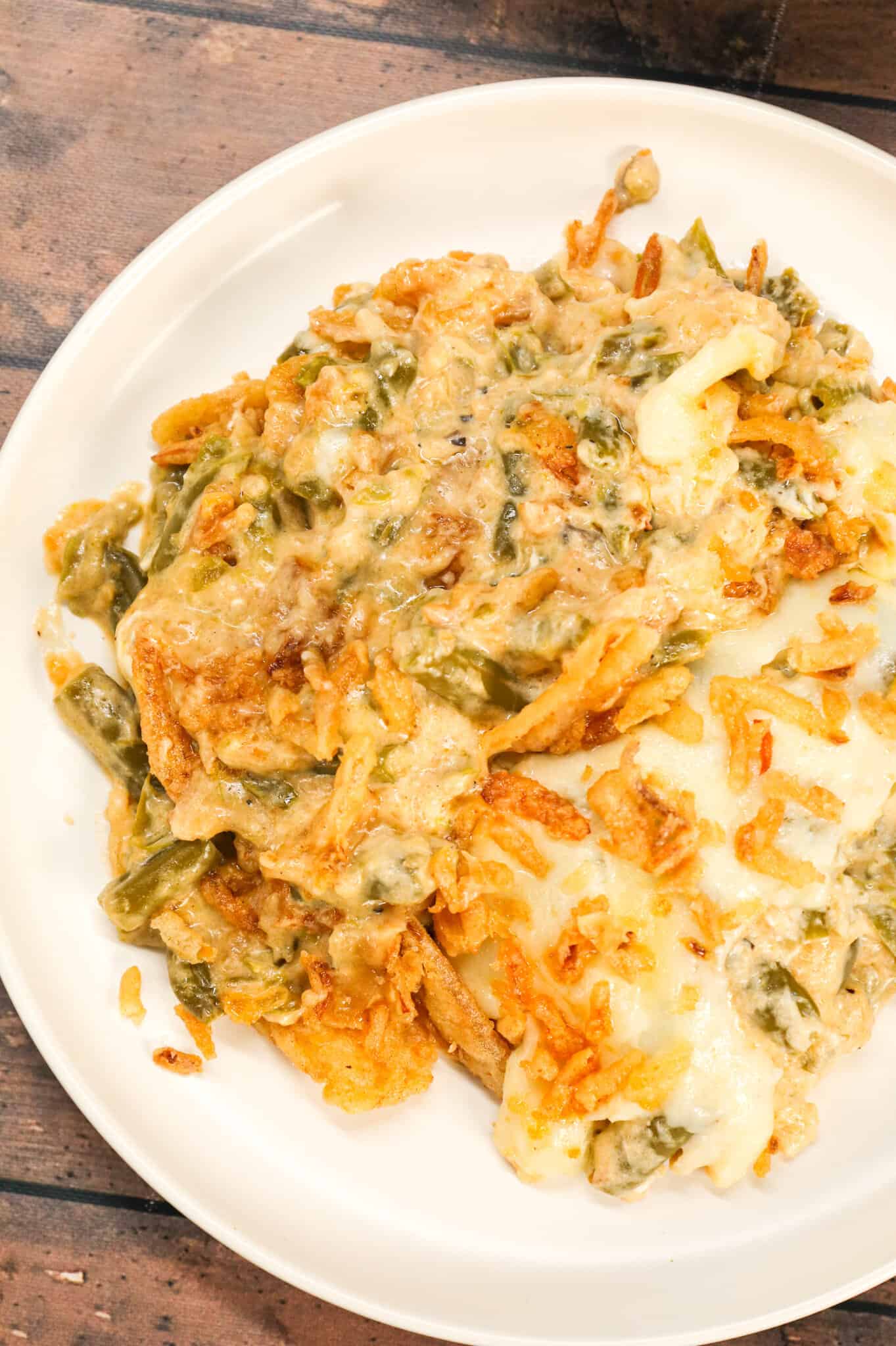 Crock Pot Green Bean Casserole is an easy slow cooker side dish recipe loaded with cut green beans, cream of mushroom soup, cheddar soup, cream cheese, provolone cheese and French's crispy fried onions.