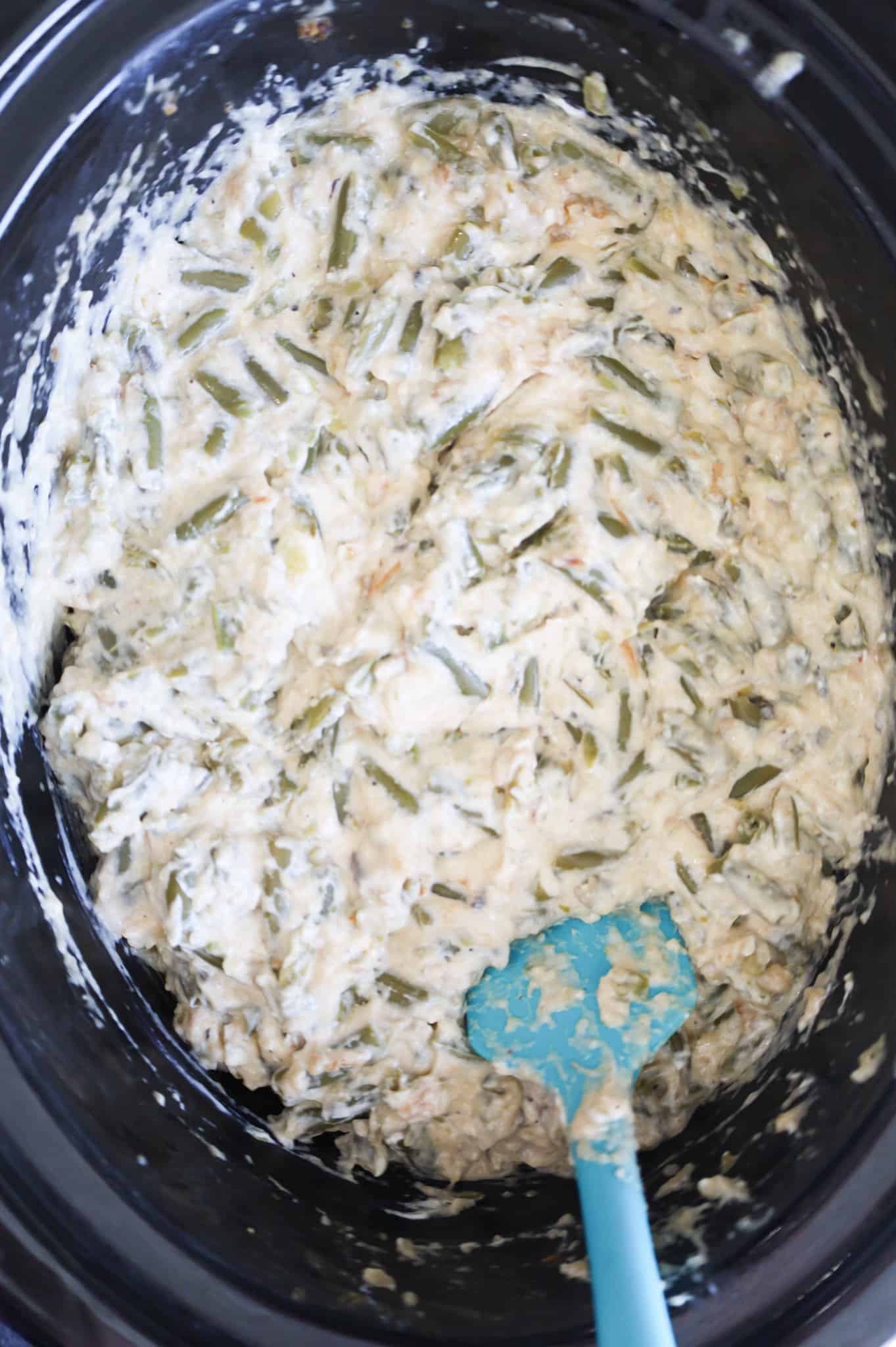 creamy green bean mixture in a crock pot