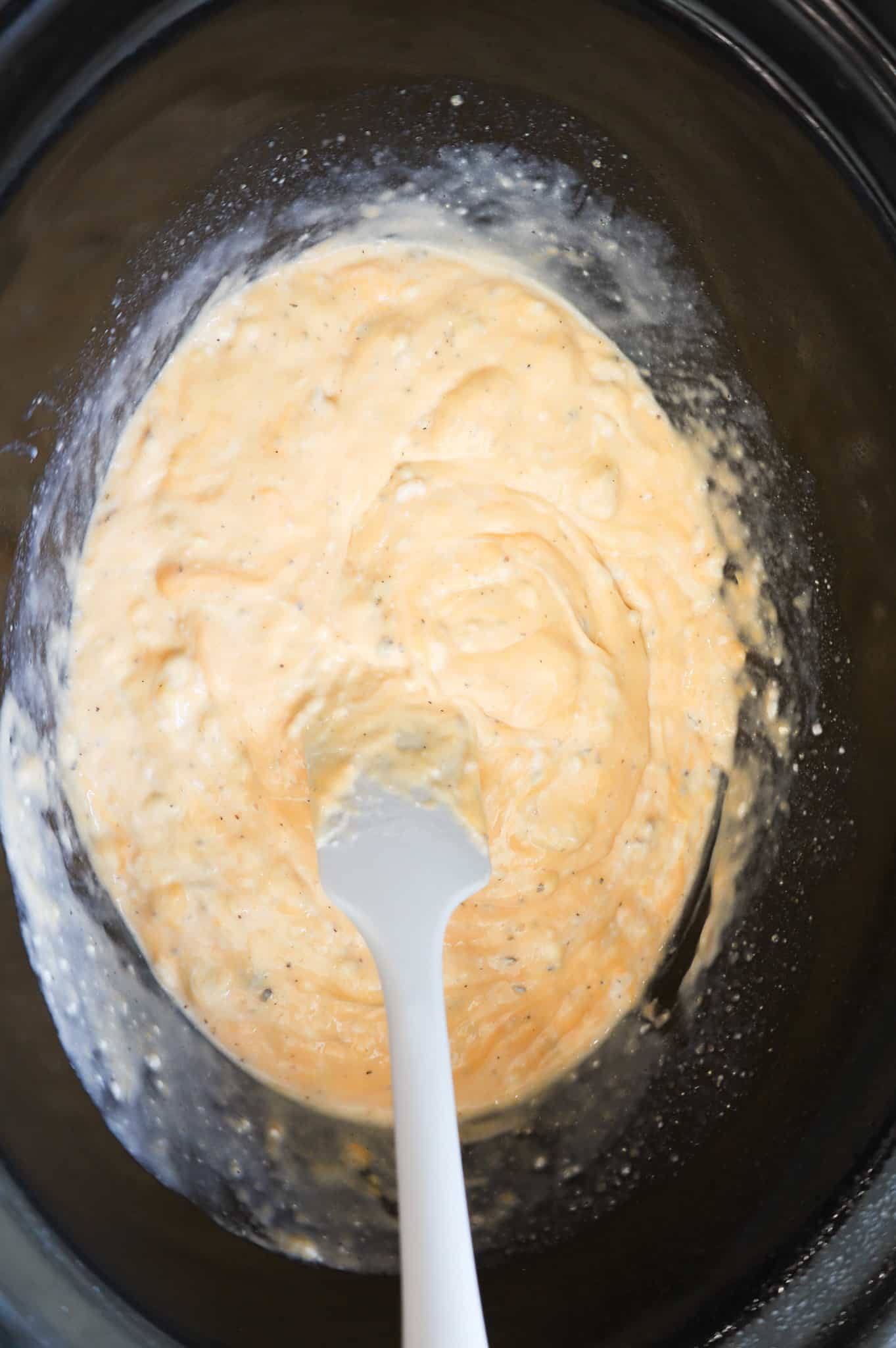 cheddar and mushroom soup mixture in a crock pot