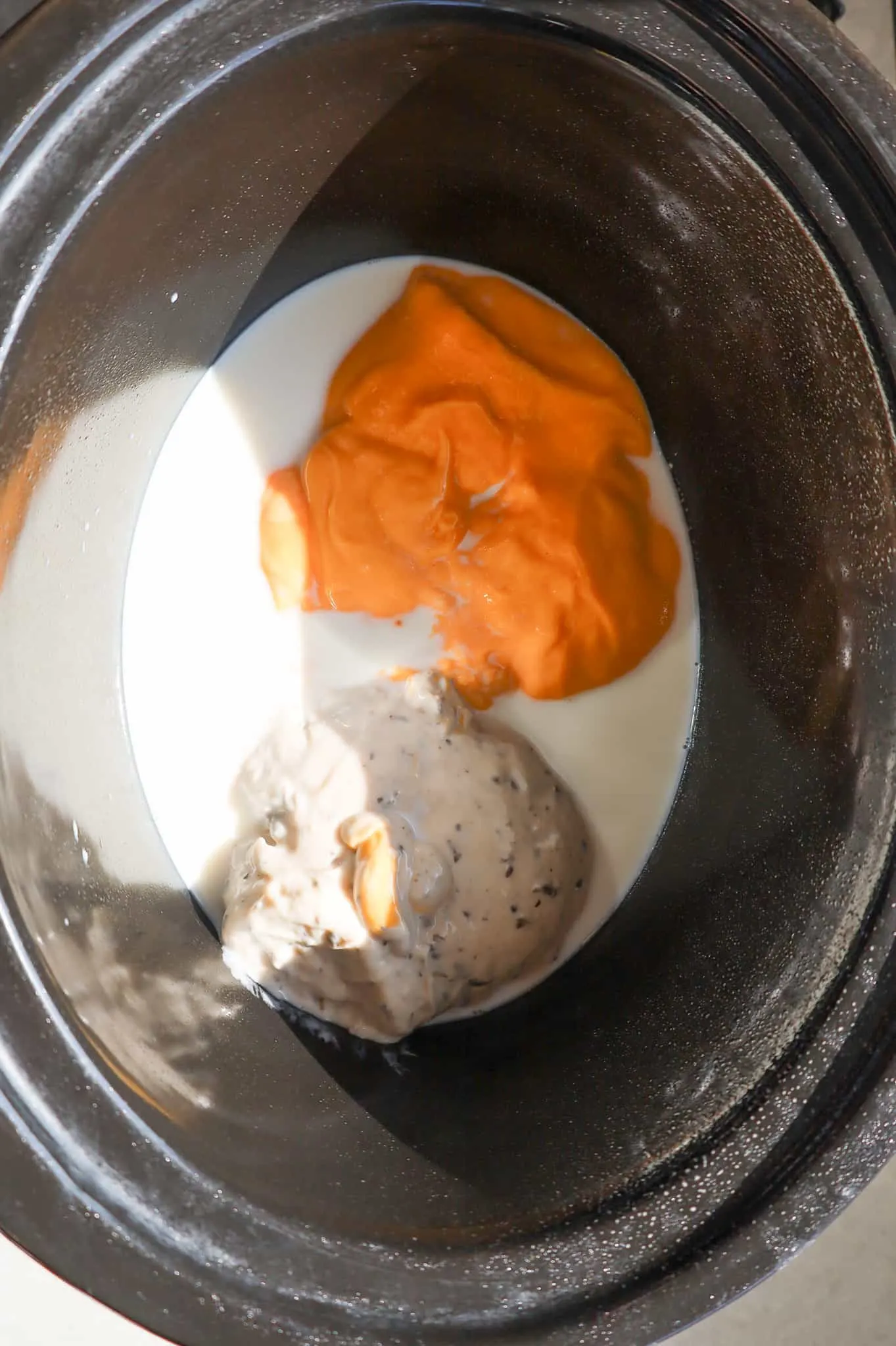 cheddar soup, mushroom soup and milk in a crock pot