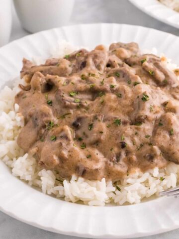 Steak and Rice is a hearty comfort food dish with tender pieces of steak cooked in a creamy mushroom sauce and served over rice.