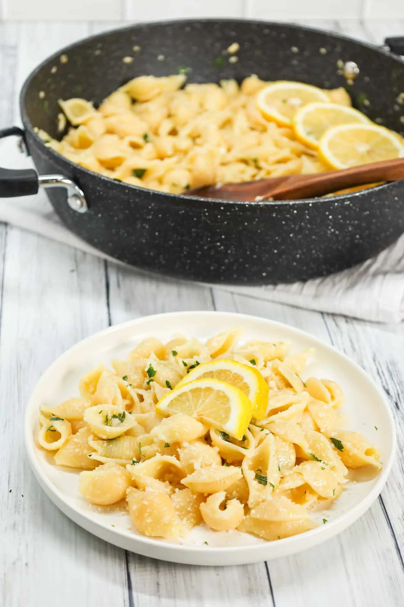 Lemon Garlic Pasta is a simple dinner recipe using shell pasta tossed in a lemon garlic butter sauce and topped with grated parmesan and chopped parsley.