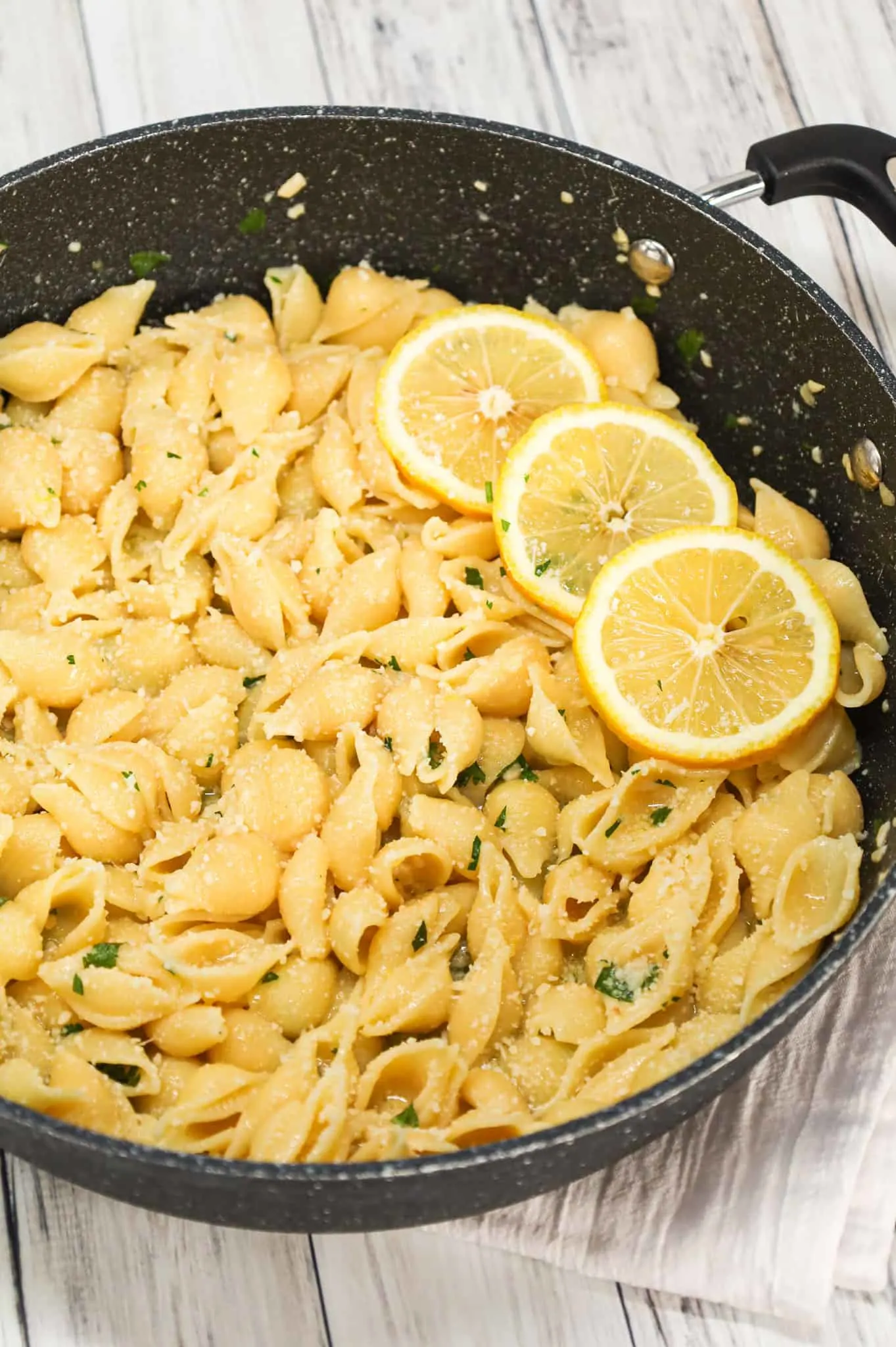 Lemon Garlic Pasta is a simple dinner recipe using shell pasta tossed in a lemon garlic butter sauce and topped with grated parmesan and chopped parsley.