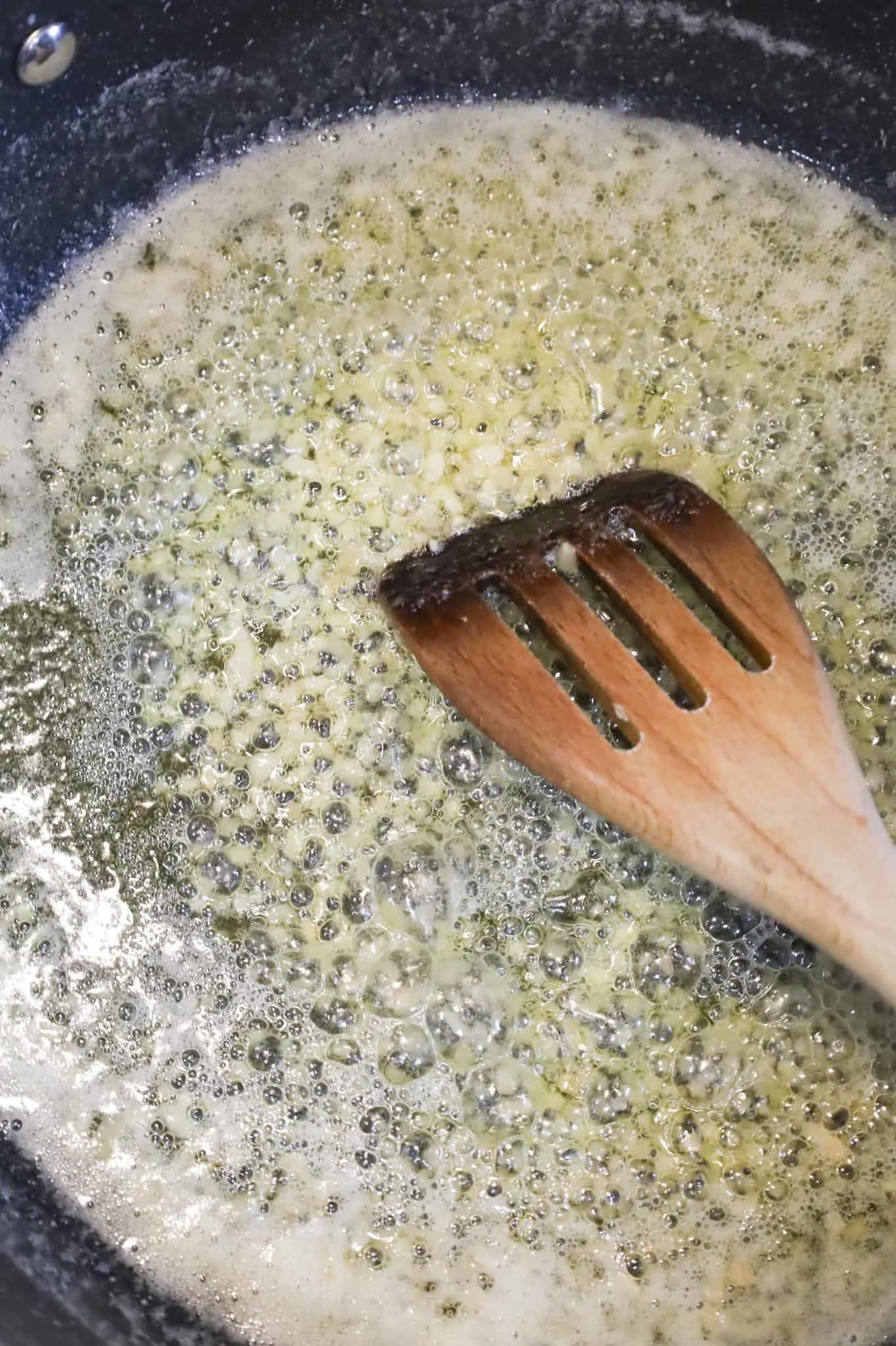 cooking minced garlic in oil and butter in a skillet