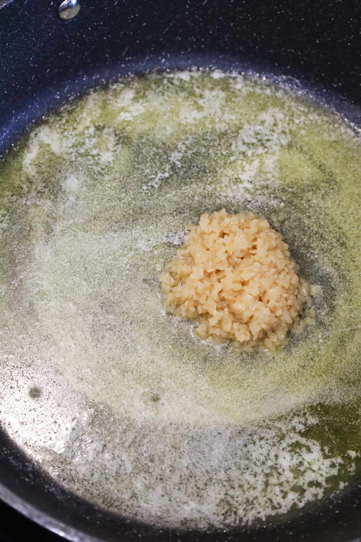 minced garlic added to skillet with olive oil and melted butter