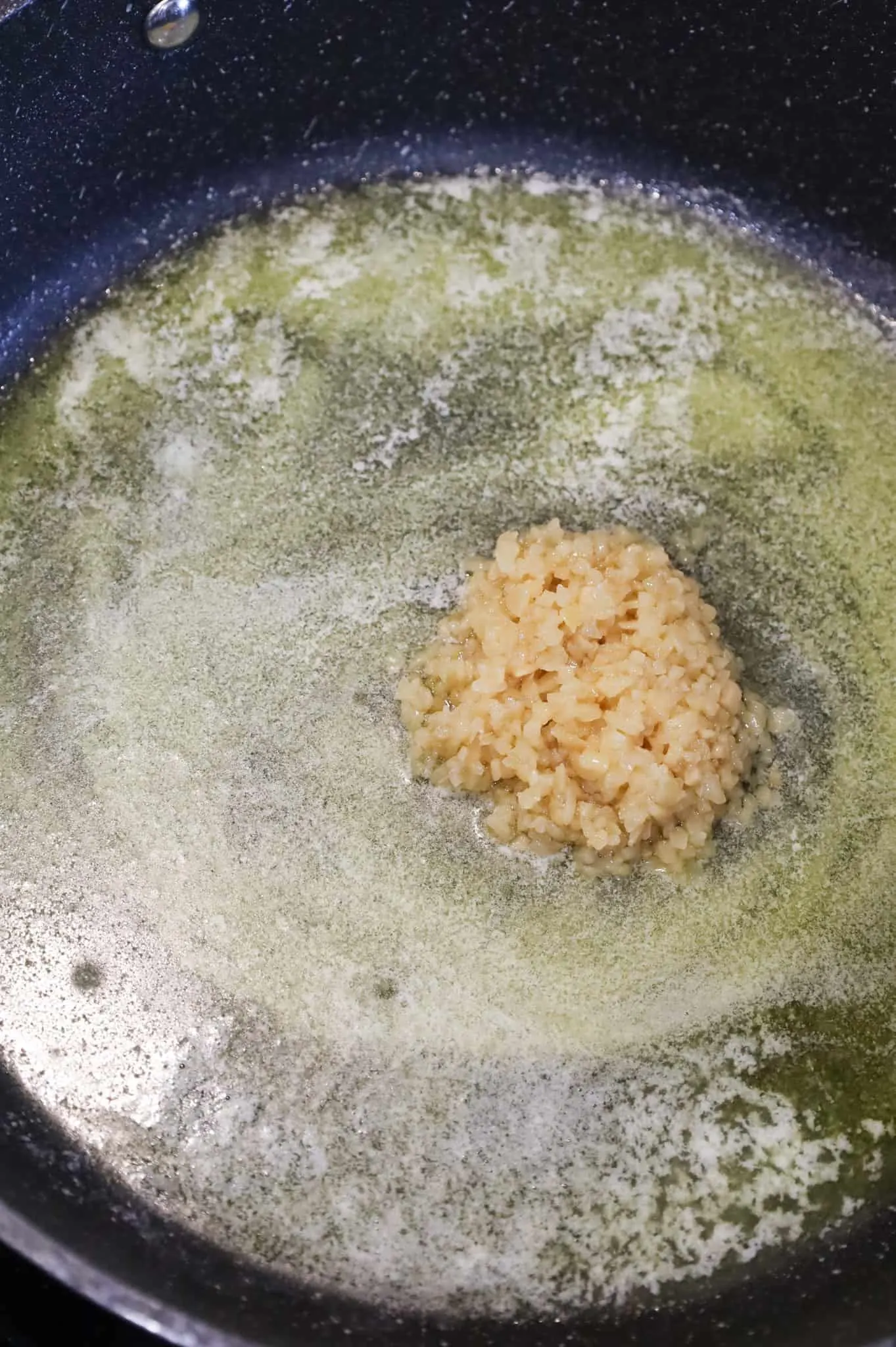 minced garlic added to skillet with olive oil and melted butter
