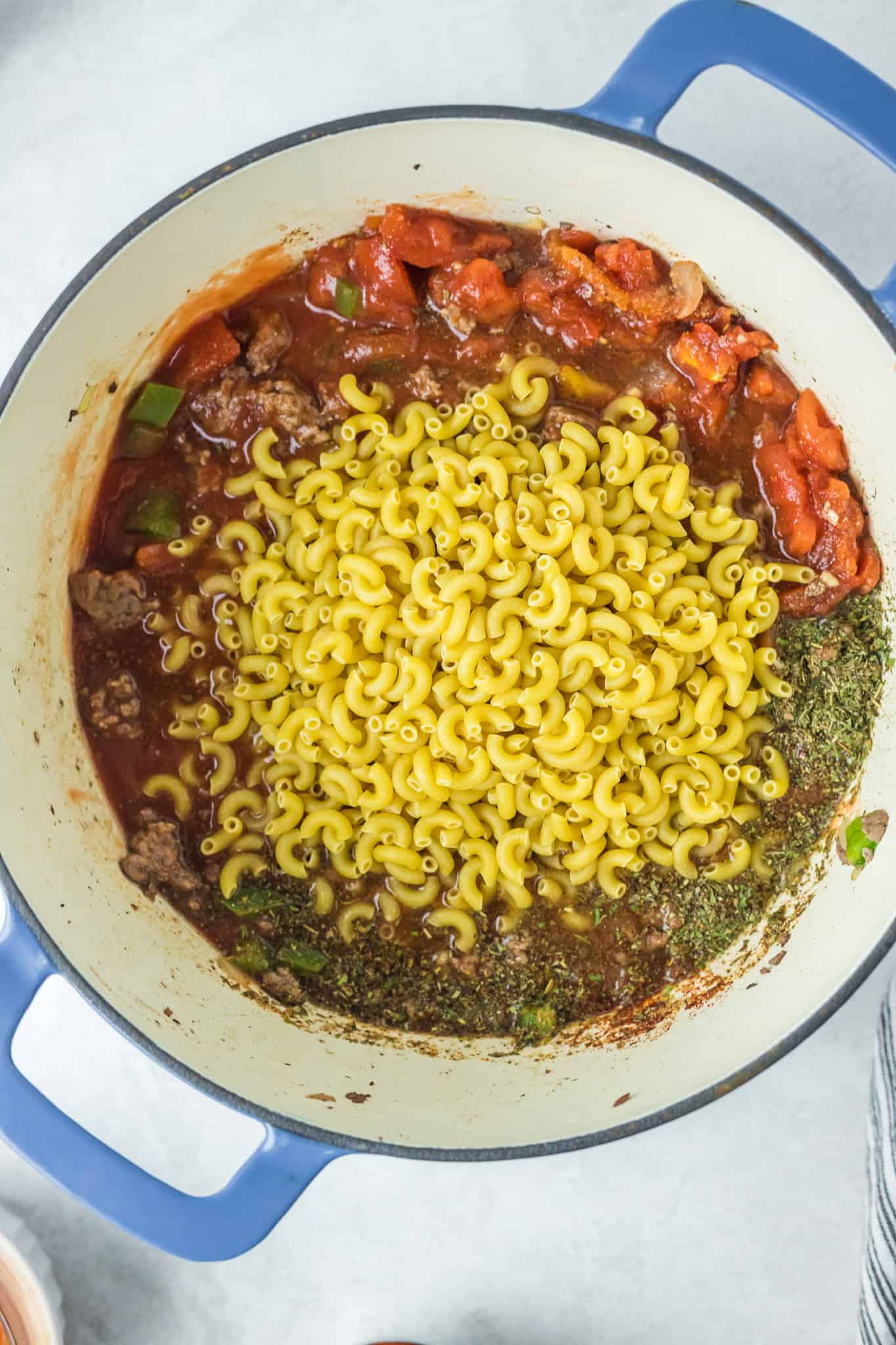 macaroni noodles added to pot with tomato sauce, diced tomatoes and ground beef