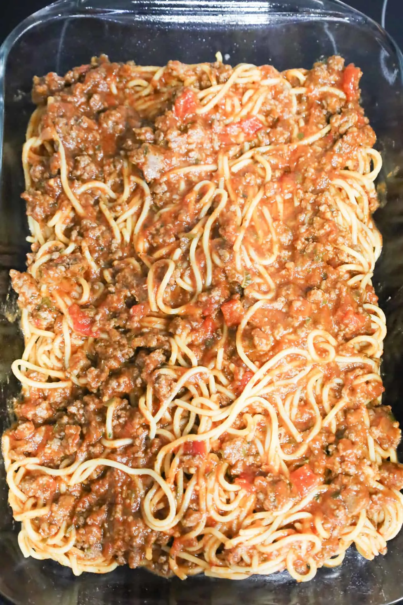 spaghetti, marinara and ground beef mixture in a baking dish