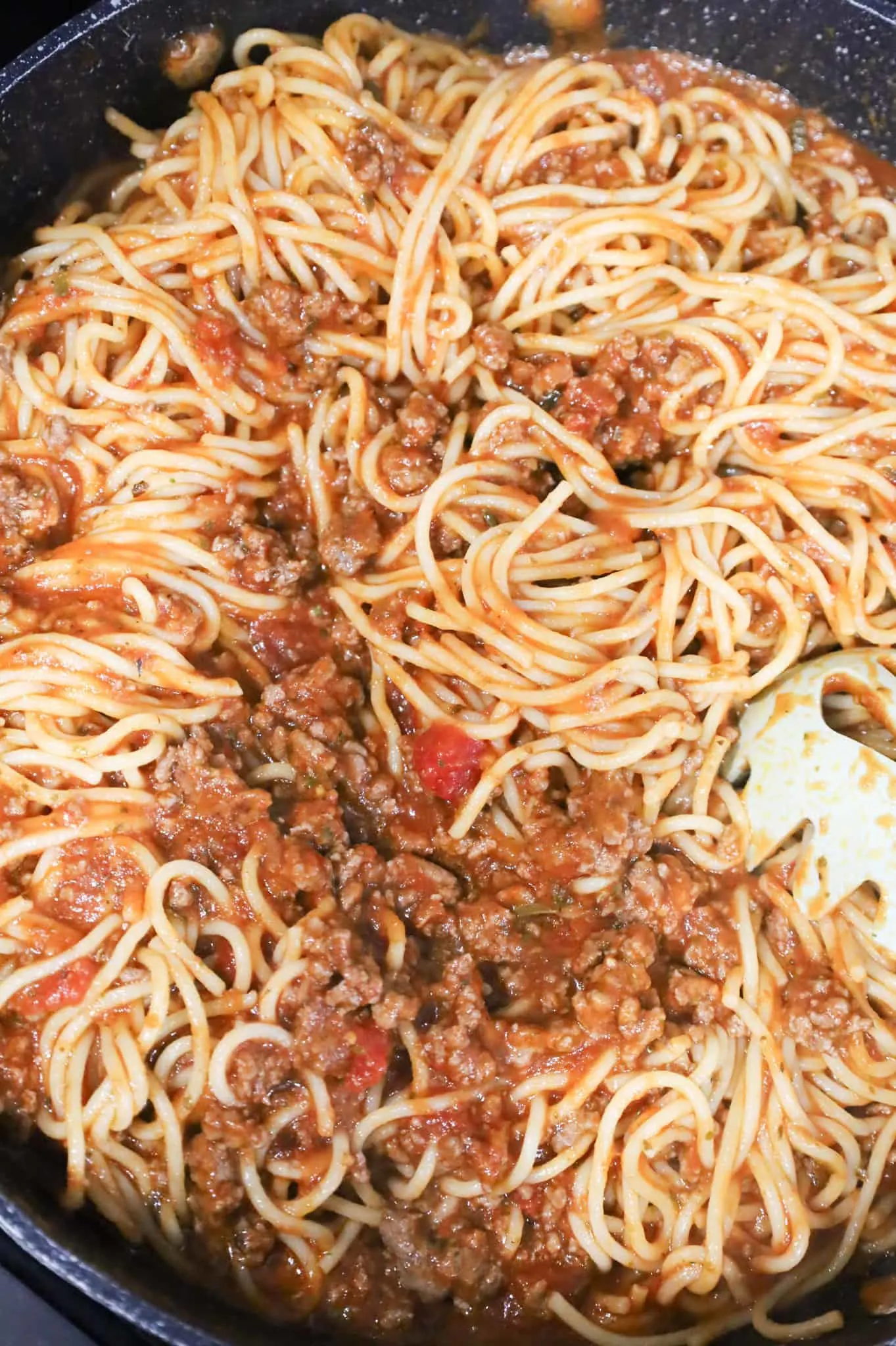 spaghetti, marinara and ground beef mixture in a saute pan