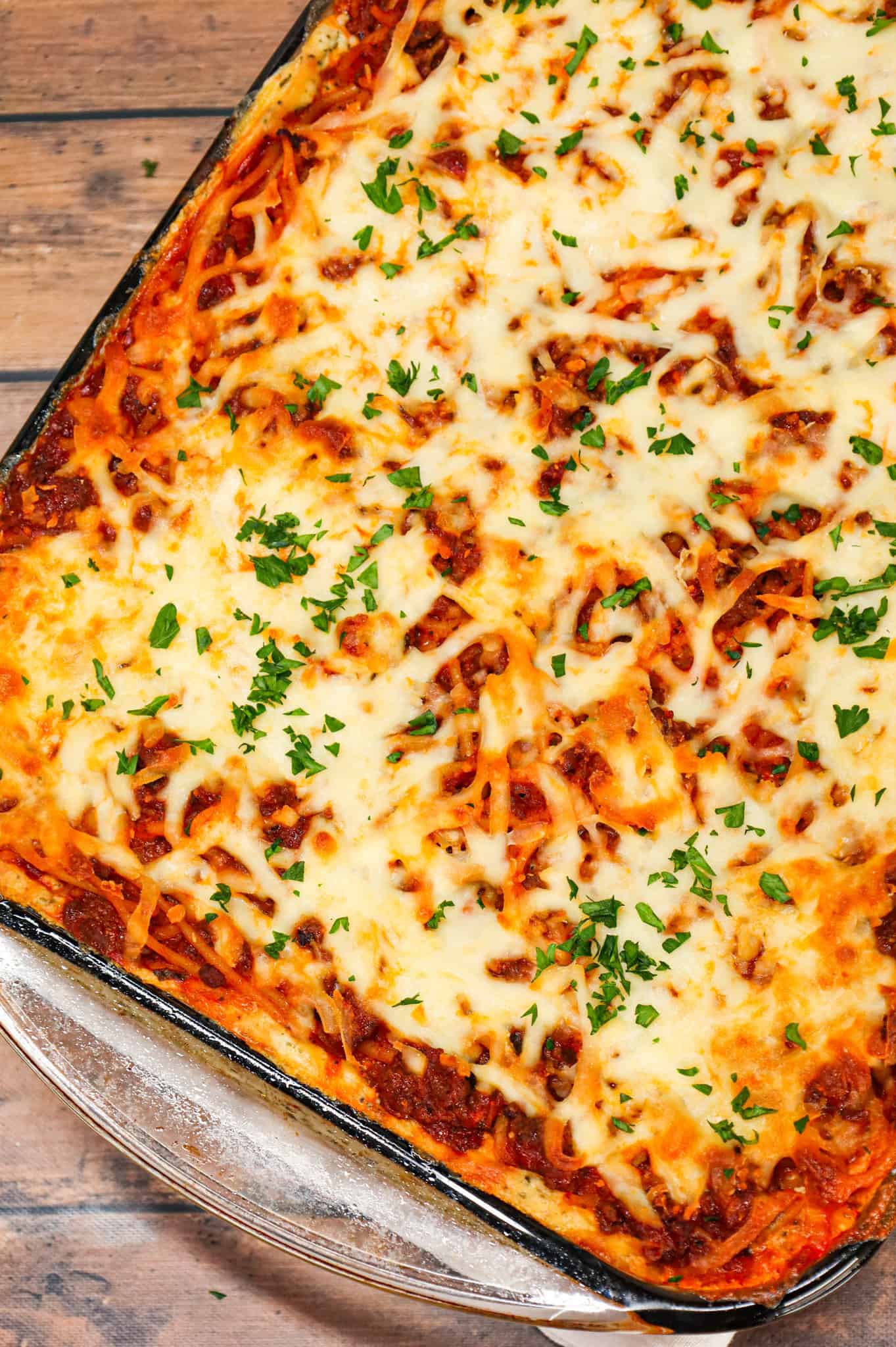 Spaghetti Casserole is a hearty dinner recipe loaded with ground beef, marinara, ricotta, sour cream, mozzarella and parmesan cheese.