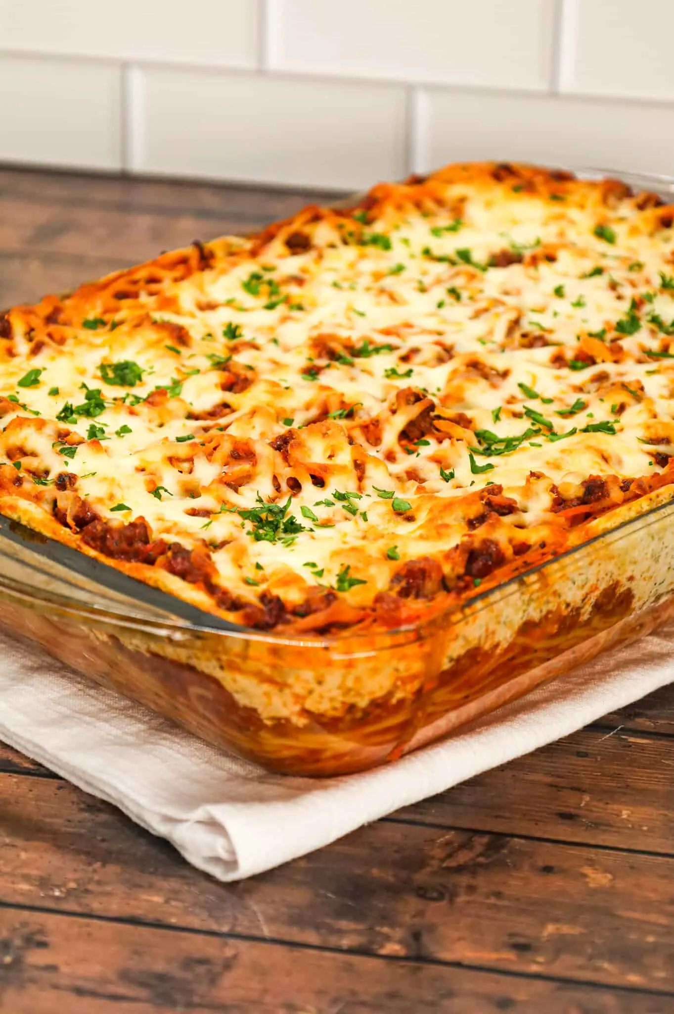 Spaghetti Casserole is a hearty dinner recipe loaded with ground beef, marinara, ricotta, sour cream, mozzarella and parmesan cheese.