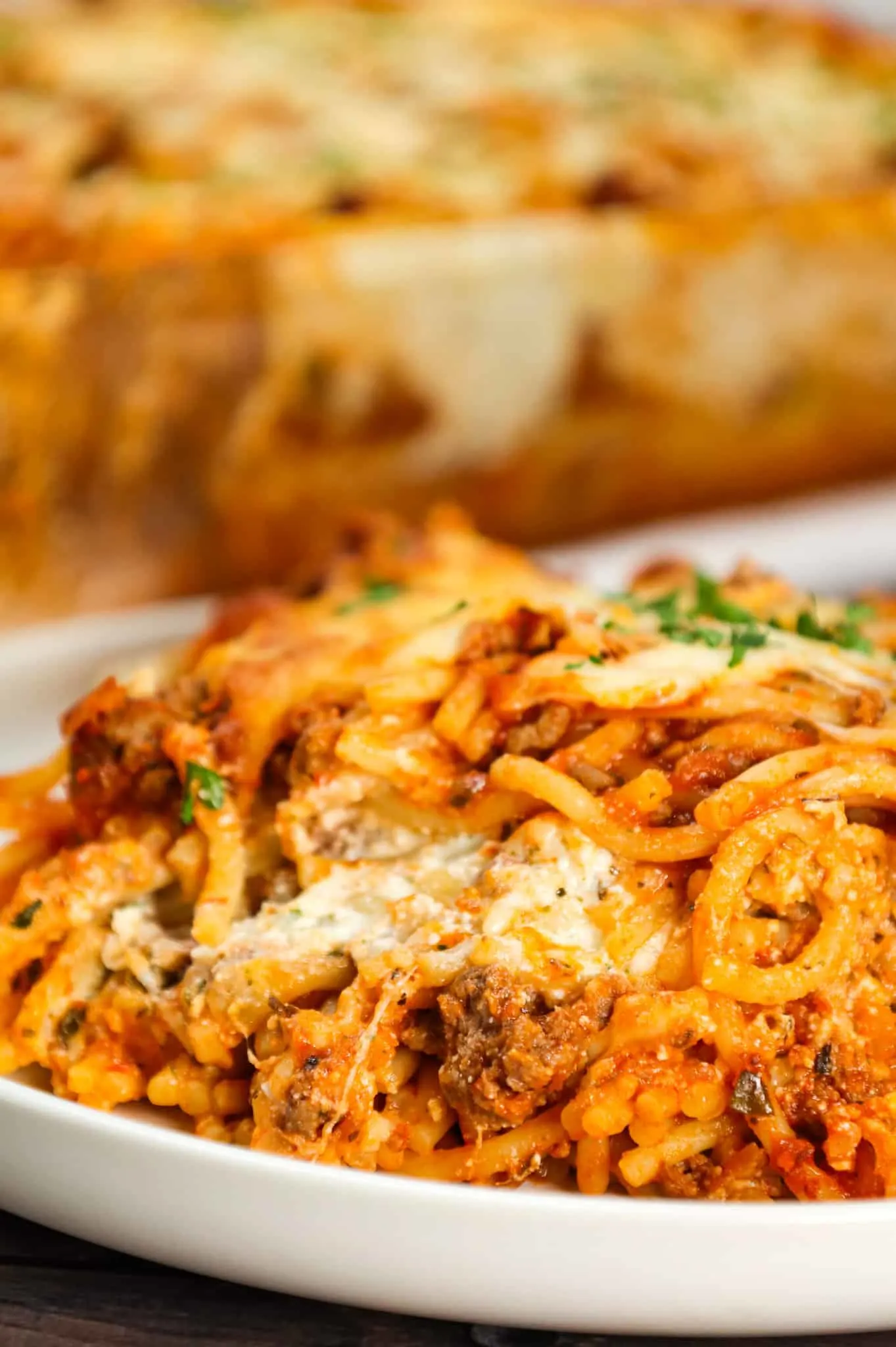 Spaghetti Casserole is a hearty dinner recipe loaded with ground beef, marinara, ricotta, sour cream, mozzarella and parmesan cheese.