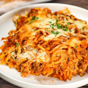 Spaghetti Casserole is a hearty dinner recipe loaded with ground beef, marinara, ricotta, sour cream, mozzarella and parmesan cheese.