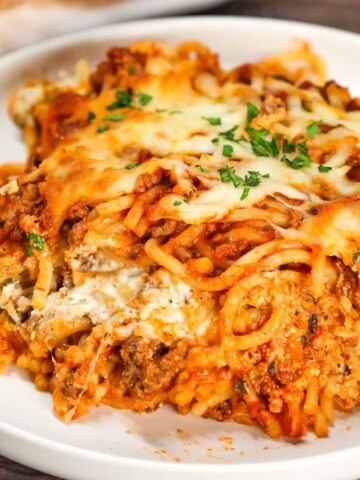 Spaghetti Casserole is a hearty dinner recipe loaded with ground beef, marinara, ricotta, sour cream, mozzarella and parmesan cheese.