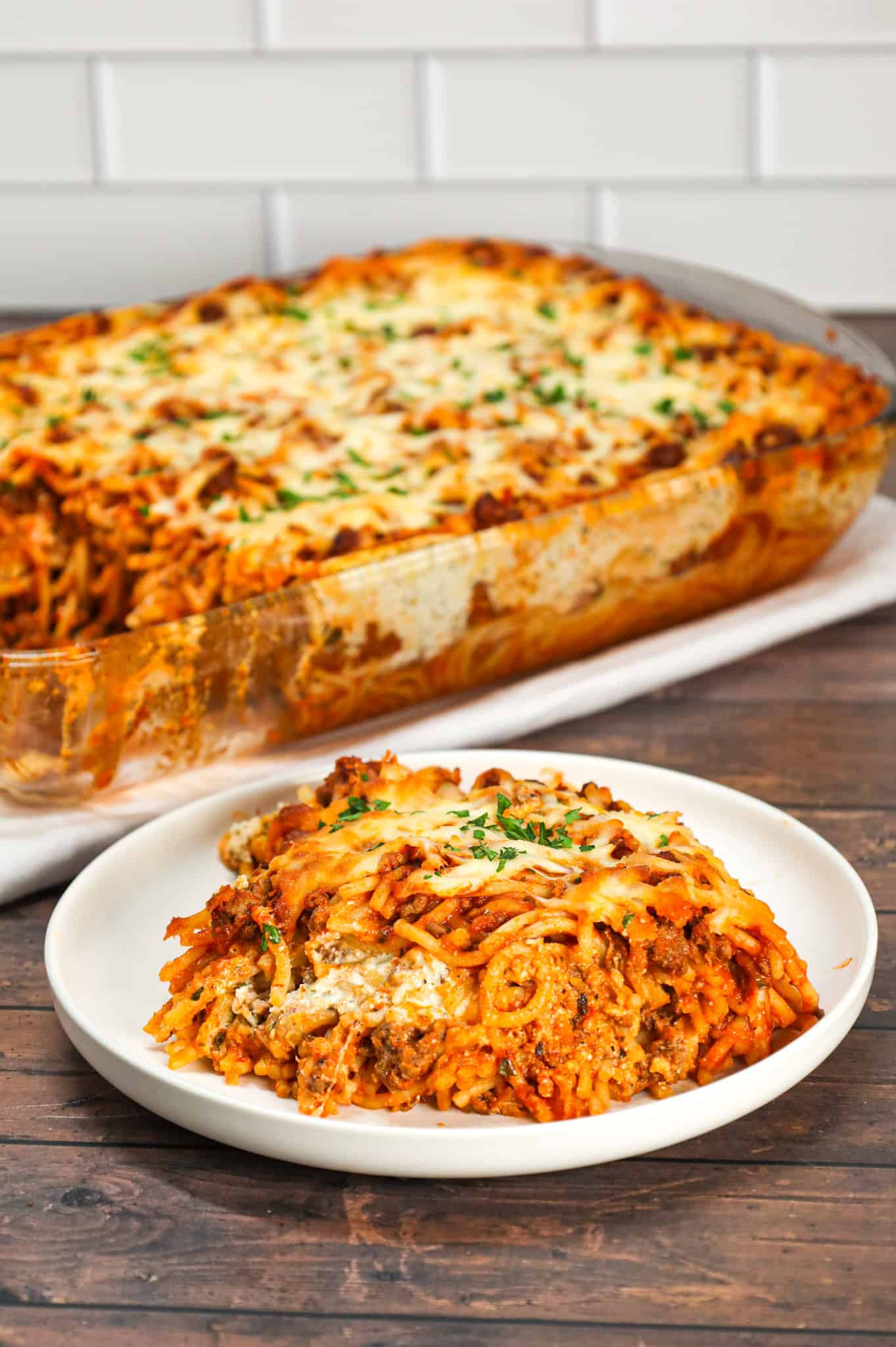 Spaghetti Casserole is a hearty dinner recipe loaded with ground beef, marinara, ricotta, sour cream, mozzarella and parmesan cheese.