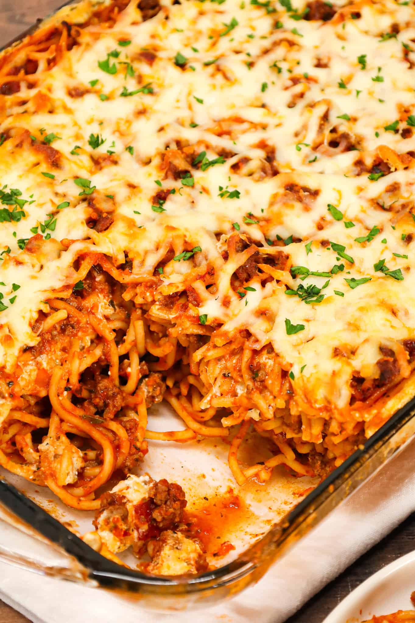 Spaghetti Casserole is a hearty dinner recipe loaded with ground beef, marinara, ricotta, sour cream, mozzarella and parmesan cheese.