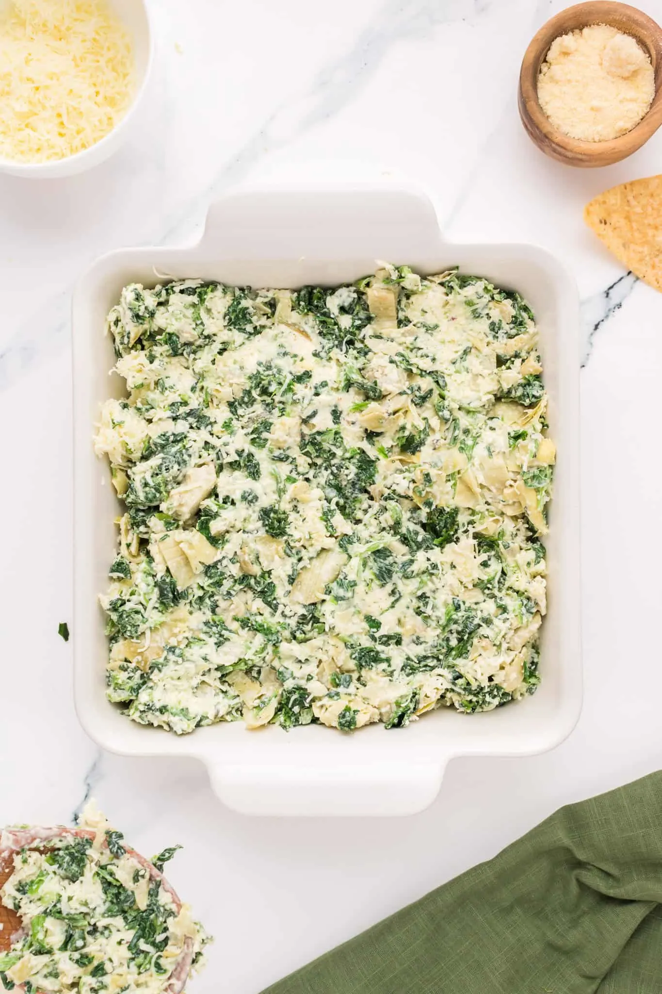 creamy spinach and artichoke mixture in a baking dish