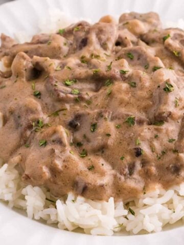 Steak and Rice is a hearty comfort food dish with tender pieces of steak cooked in a creamy mushroom sauce and served over rice.
