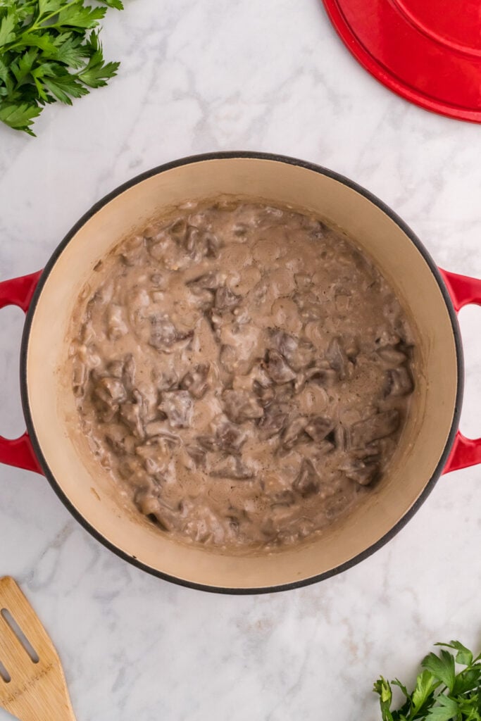 cream of mushroom soup and steak mixture in a dutch oven