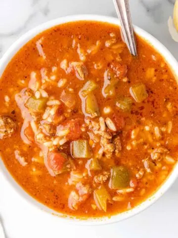 Stuffed Pepper Soup is a hearty soup recipe loaded with ground beef, diced green bell peppers, diced tomatoes and rice.