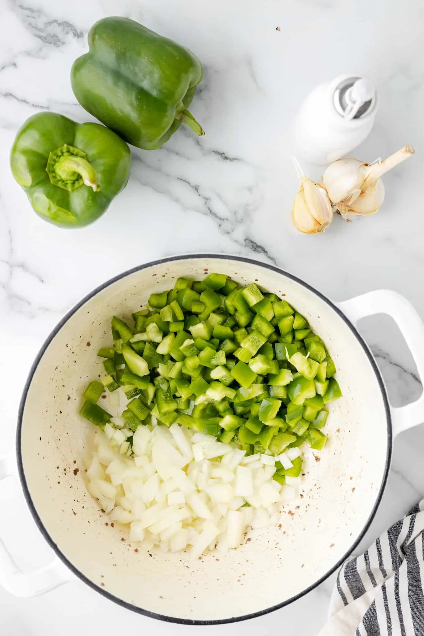diced onions and diced green peppers in a pot