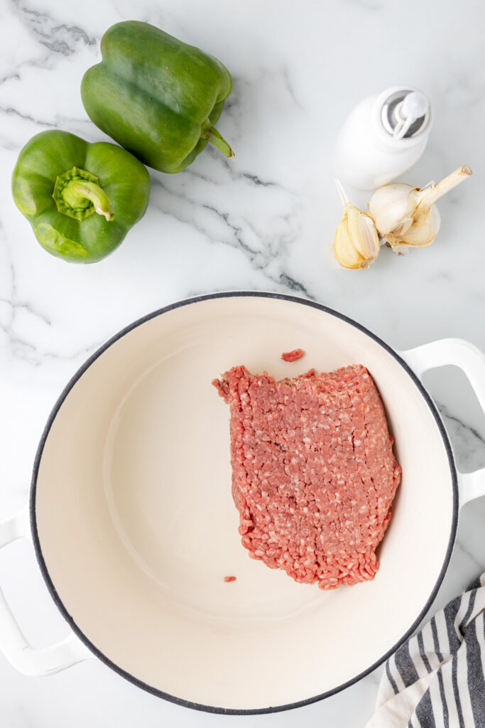 ground beef in a pot before cooking