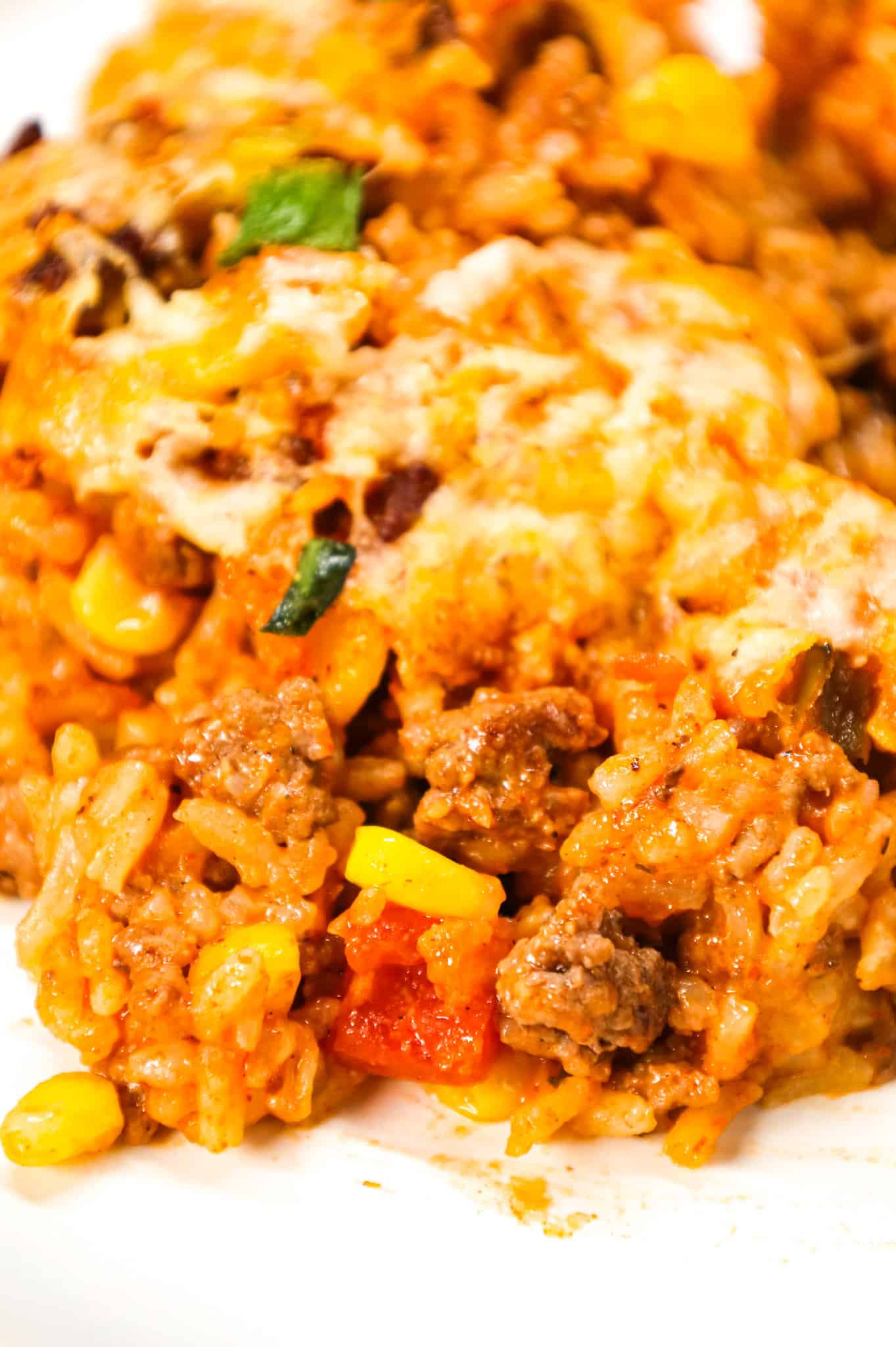 Taco Rice Casserole is a hearty ground beef casserole loaded with instant rice, condensed cheddar soup, corn, salsa, taco seasoning, ranch dressing mix, chopped green onions and a shredded Mexican cheese blend.