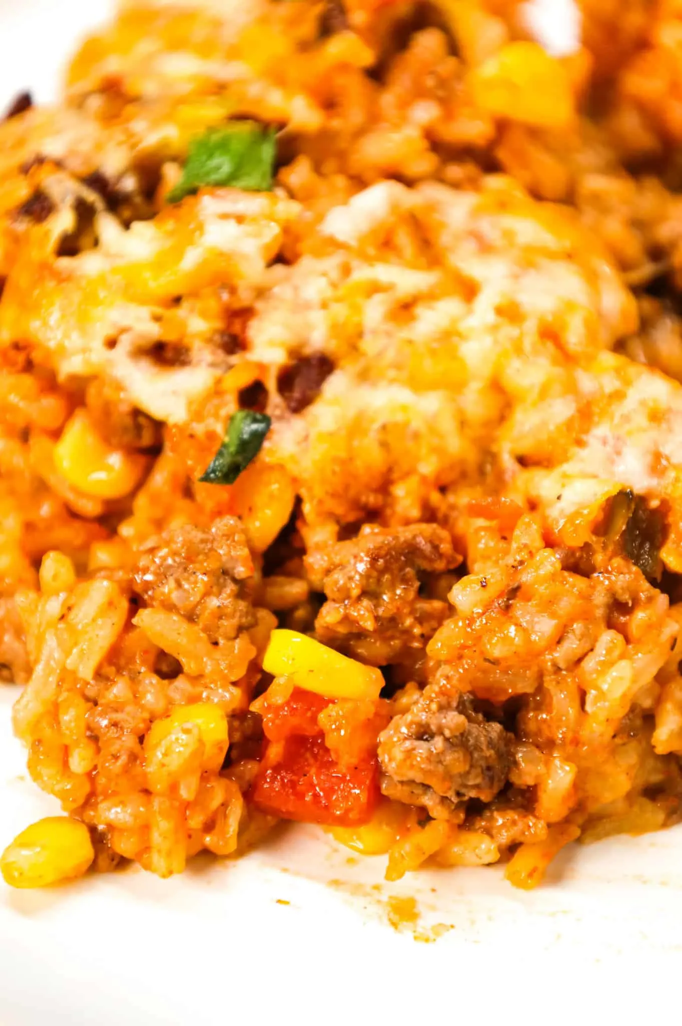 Taco Rice Casserole is a hearty ground beef casserole loaded with instant rice, condensed cheddar soup, corn, salsa, taco seasoning, ranch dressing mix, chopped green onions and a shredded Mexican cheese blend.